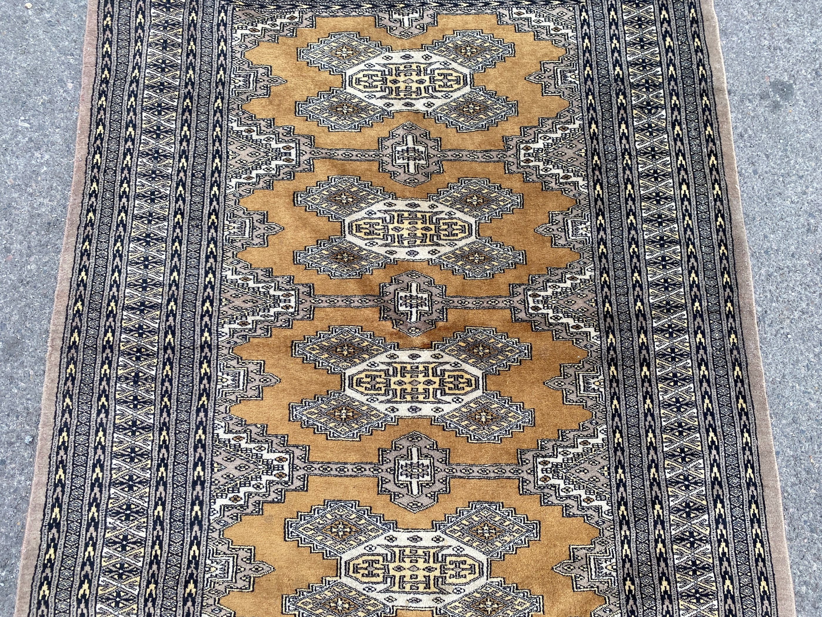 A Bokhara gold ground rug, 190 x 136cm